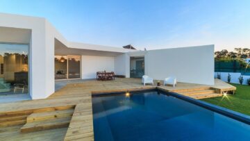 A pool that is in the middle of a deck.